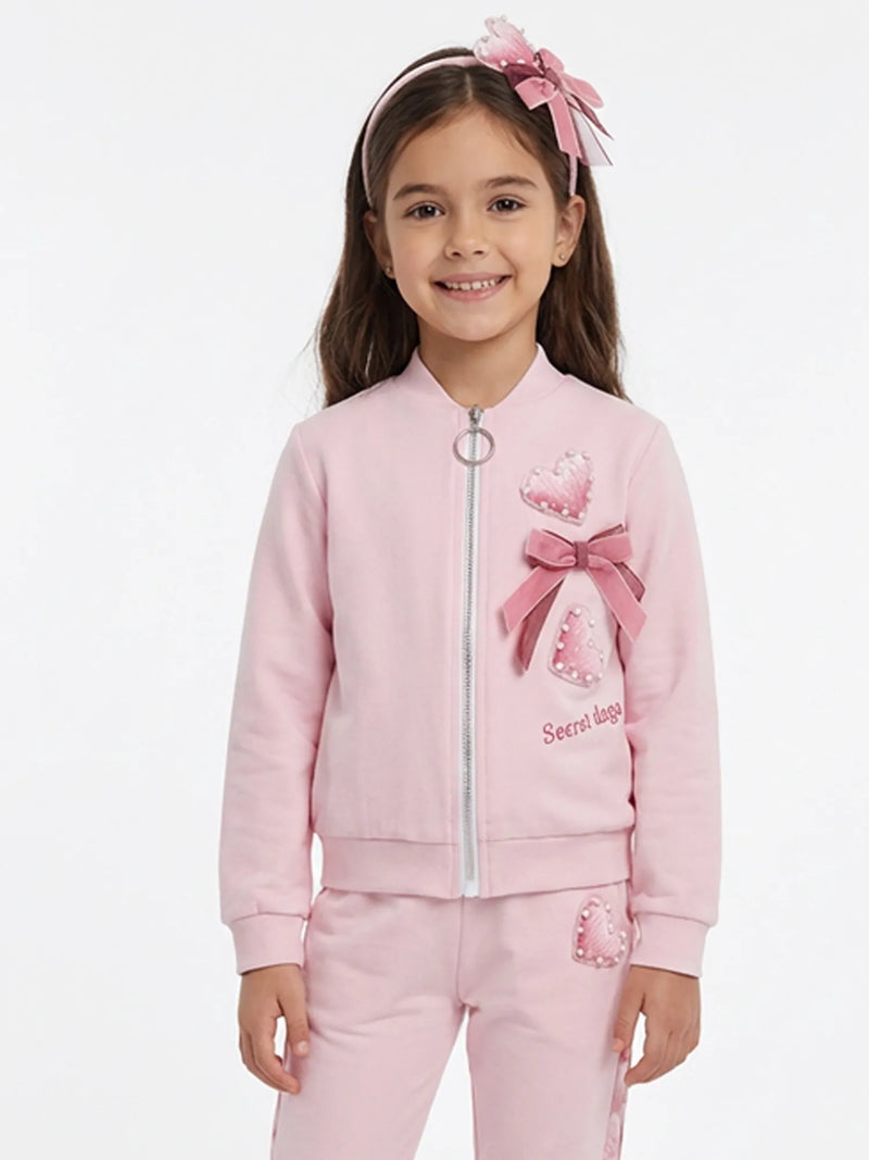 Smiling Girl modelling the Daga bow jacket.