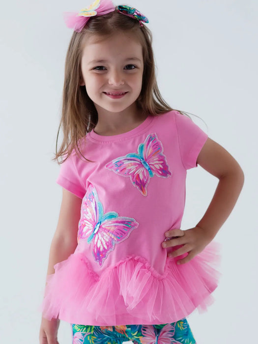 Smiling girl modelling the Daga butterfly bows.