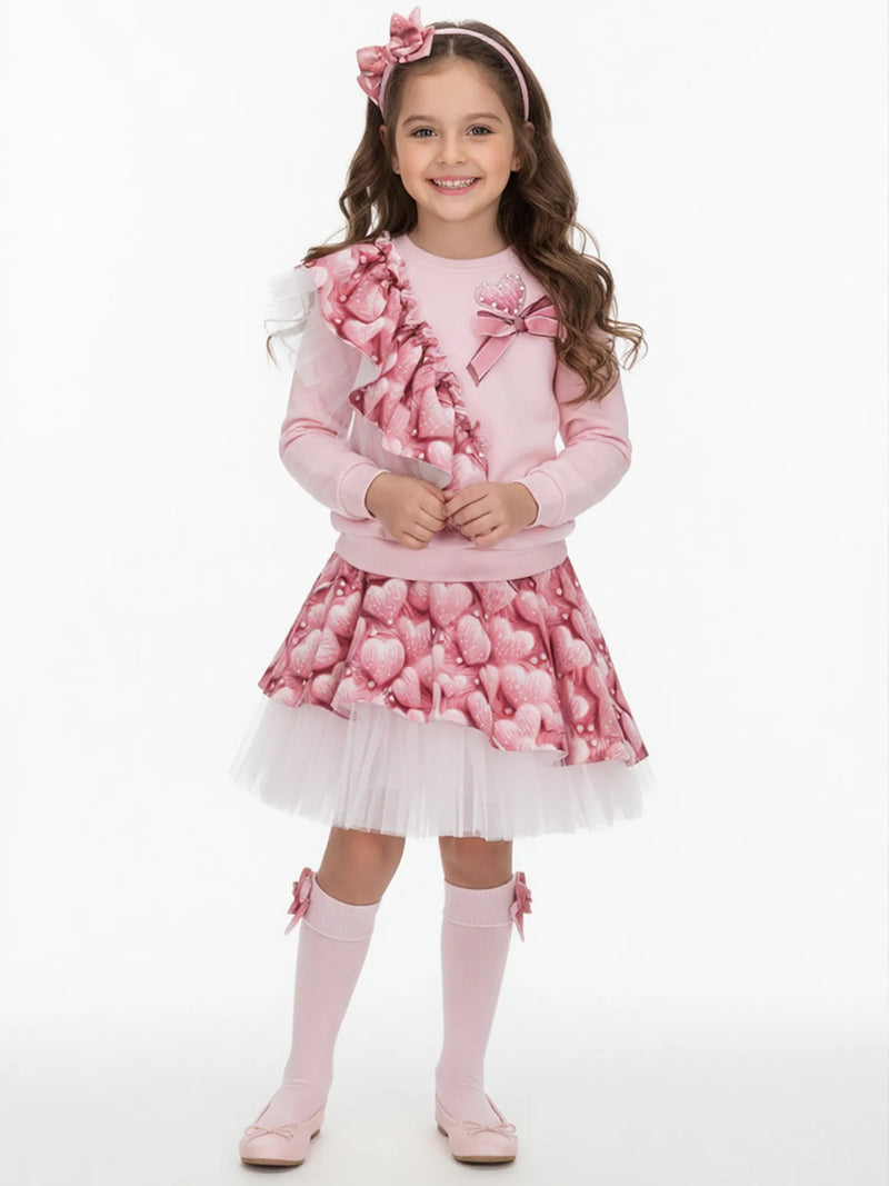 Girl wearing the Daga heart print skirt set.
