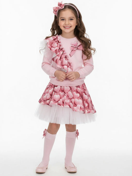 Girl wearing the Daga heart print skirt set.