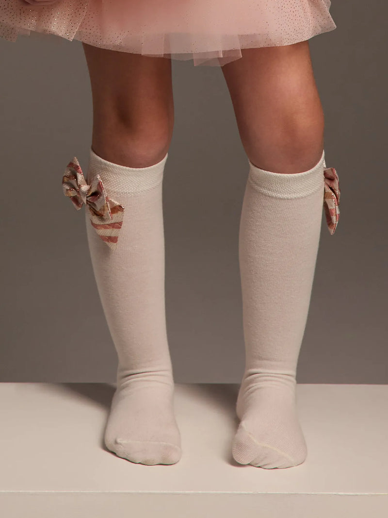 Girl modelling the Daga striped bow knee socks.