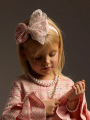 Girl wearing the Daga tweed bow headband.