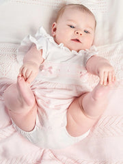 Baby girl modelling the Dandelion ruffled romper.