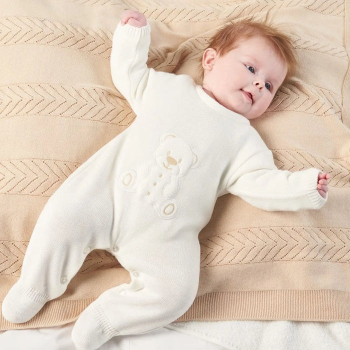 Baby wearing the Dandelion teddy bear babygrow.