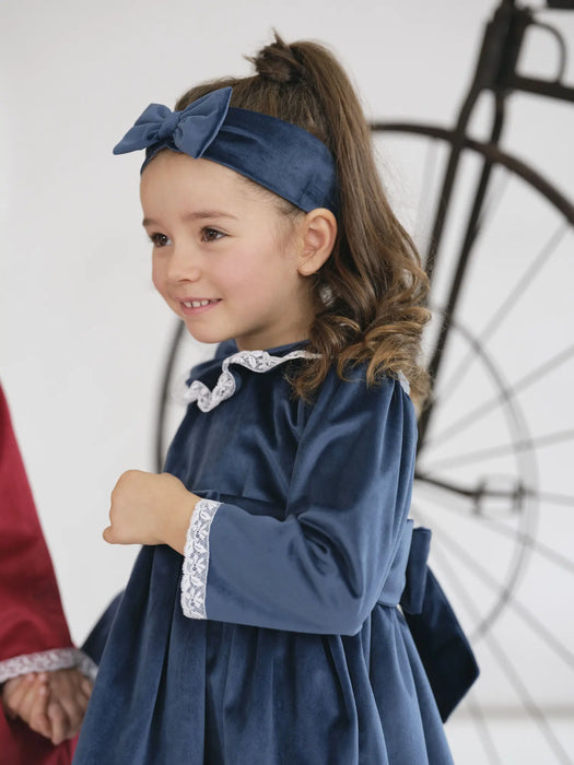 Smiling girl modelling the Deolinda velvet dress.