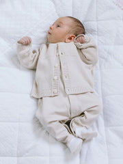 Baby in beige cypress cardigan by Emile et Rose.