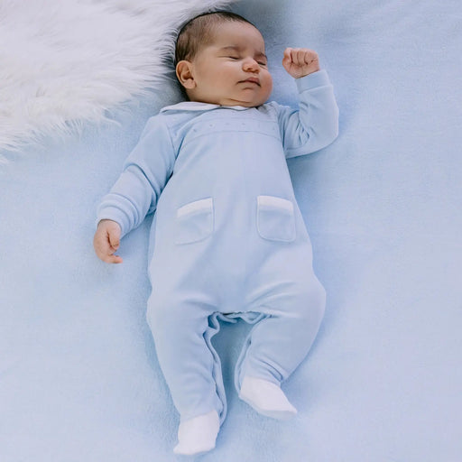 Sleeping baby boy wearing the Emile et Rose eamon babygrow.