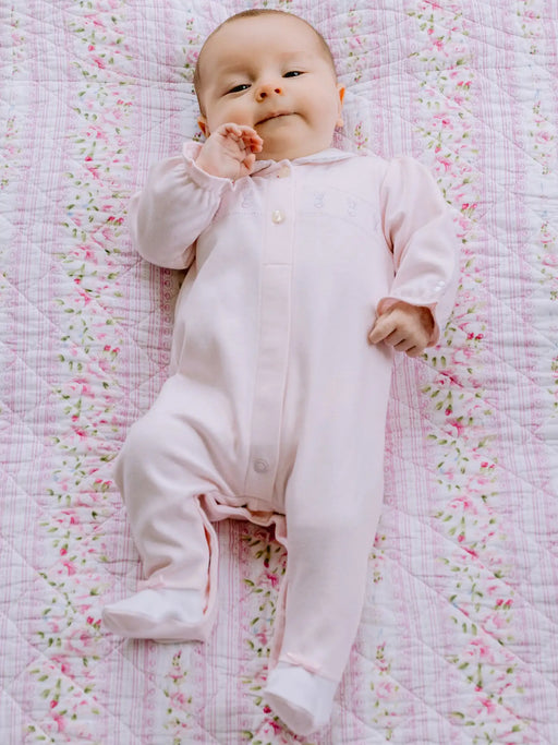 Smiling baby girl modelling the Emile et Rose helen babygrow.