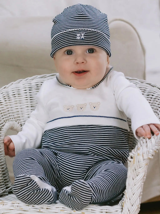 Smiling baby boy modelling the Emile et Rose jasper babygrow.