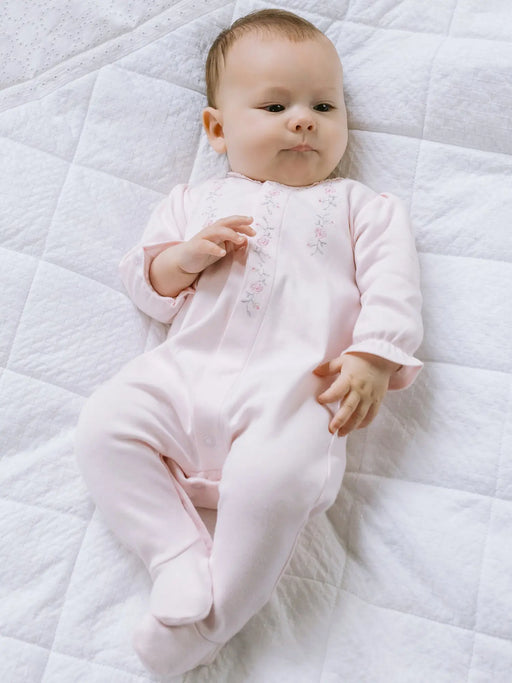 Smiling baby girl modelling the Emile et Rose jennifer babygrow.