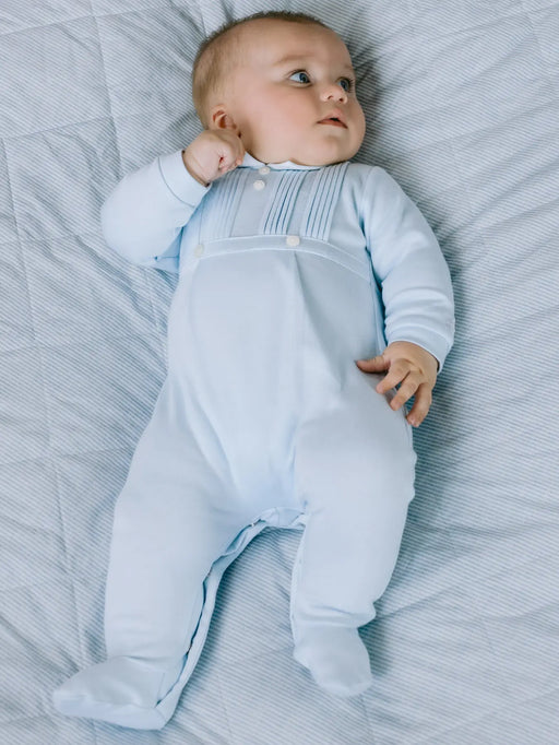 Baby boy wearing the Emile et Rose jimmy babygrow.