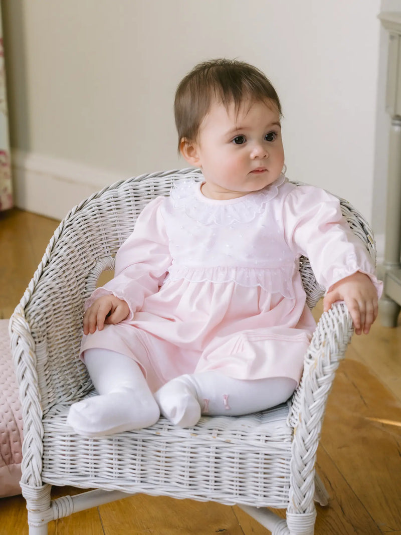 Baby girl in pink kara dress by Emile et Rose.