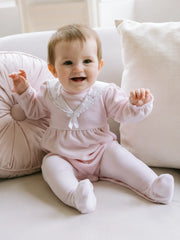 Baby girl modelling the Emile et Rose katie babygrow.
