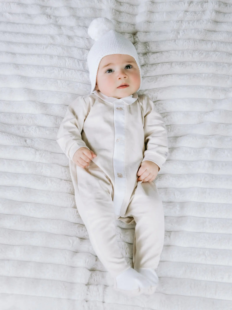 Baby in white kenton bobble hat by Emile et Rose.