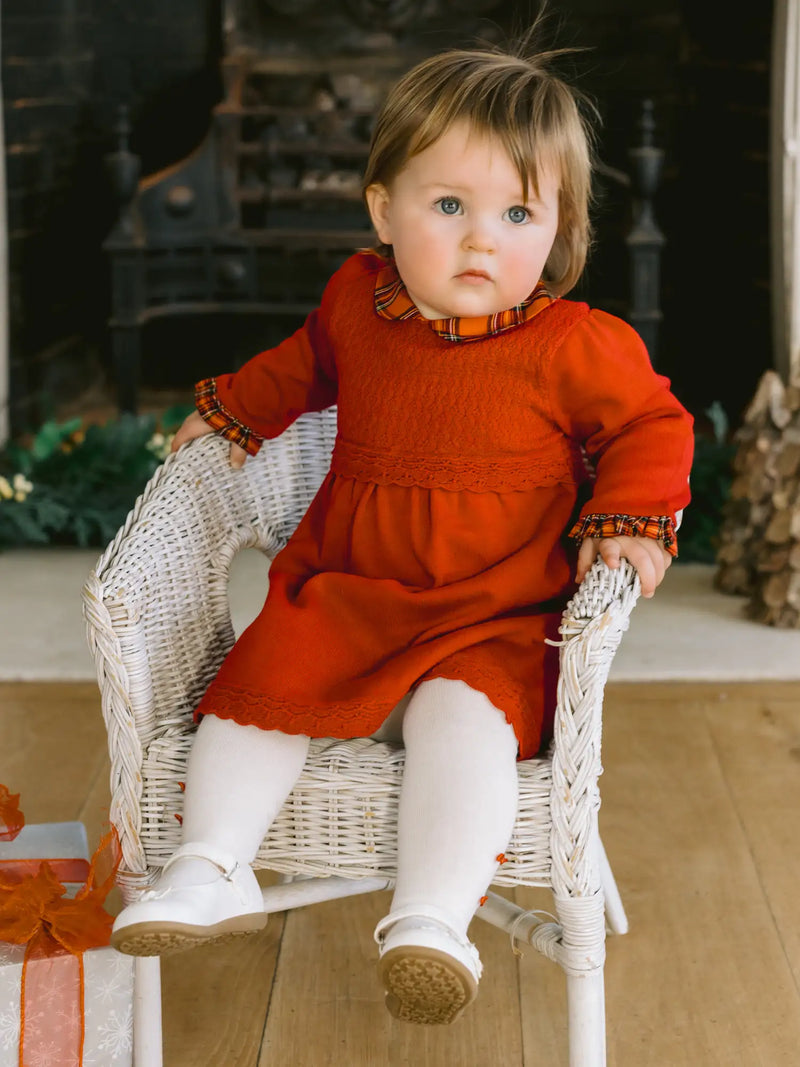Baby girl in red kesia dress by Emile et Rose.