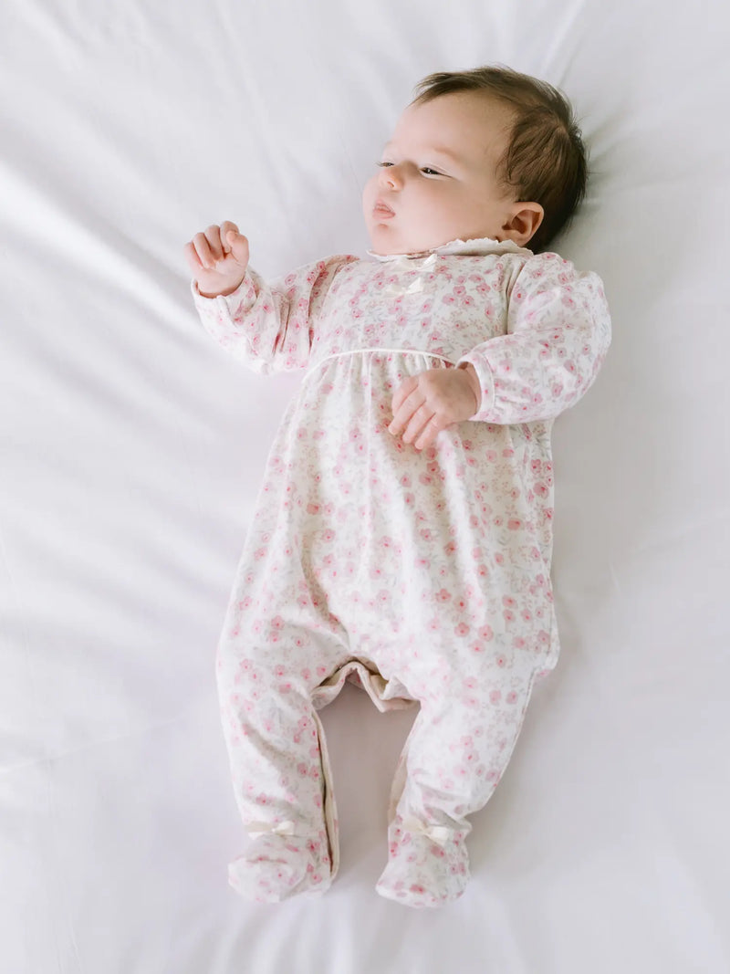 Baby girl in pink kylie babygrow by Emile et Rose.