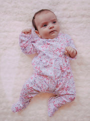 Baby girl wearing the Emile et Rose lacey babygrow.