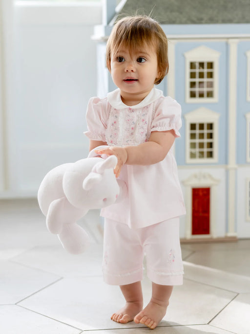 Baby girl holding a teddy bear and wearing the Emile et Rose libby shorts set.