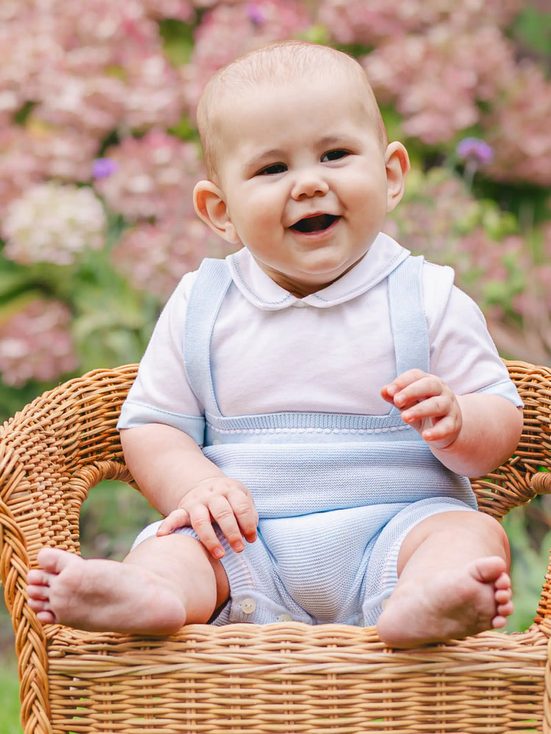 Baby boy wearing the Emile et Rose lowe romper.