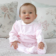 Smiling baby girl modelling the Emile et Rose maddy babygrow.