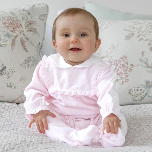 Smiling baby girl modelling the Emile et Rose maddy babygrow.