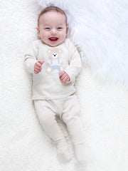 Smiling baby boy modelling the Emile et Rose marco leg warmer set.