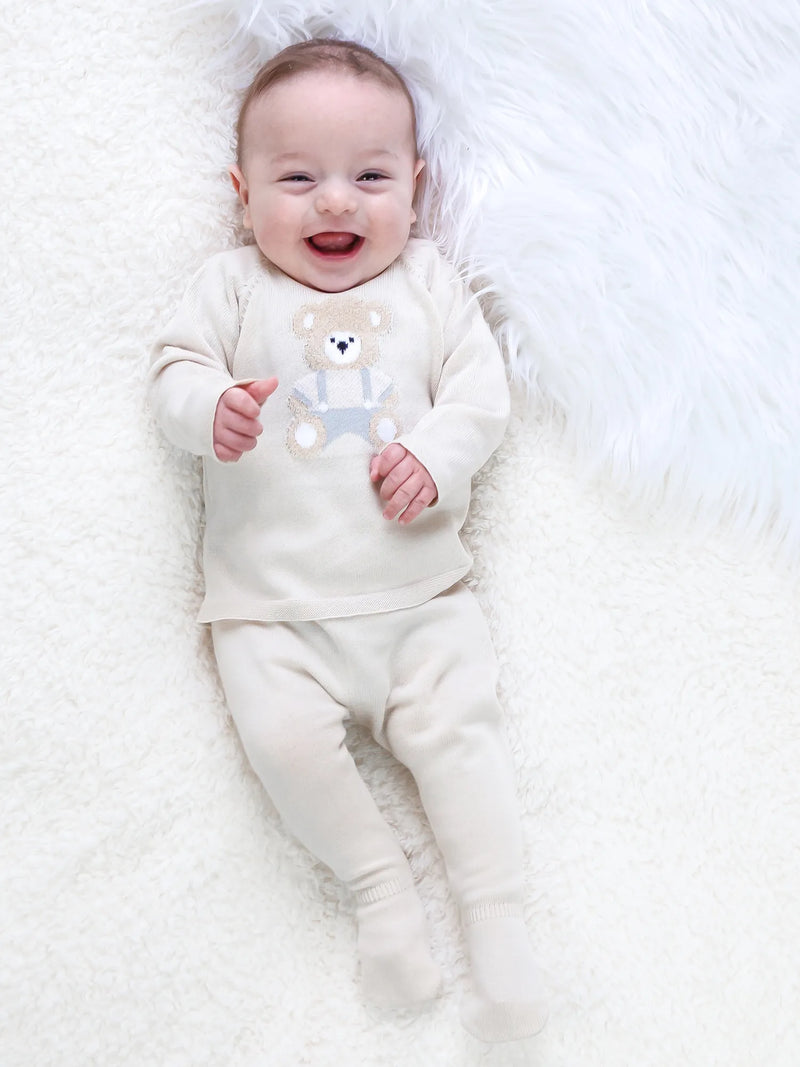 Smiling baby boy modelling the Emile et Rose marco leg warmer set.