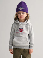 Boy modelling the GANT archive shield hoodie.