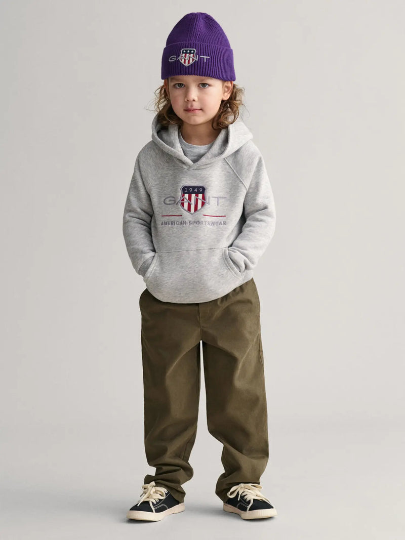 Boy modelling the GANT archive shield hoodie.