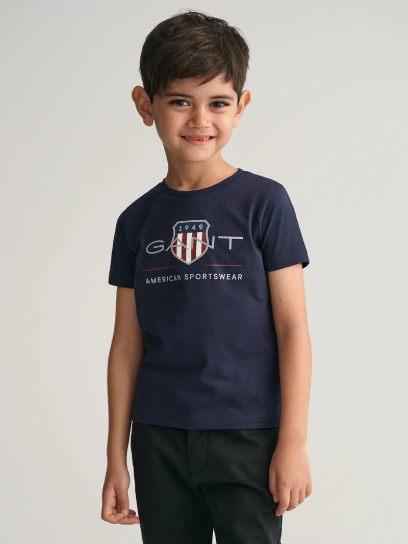 Smiling boy wearing the Gant Archive Shield T-Shirt.