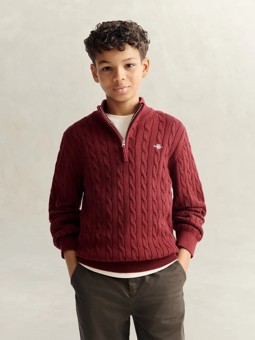 Boy in burgundy cable knit sweater by GANT.