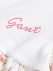 GANT floral print babygrow with pink script logo.