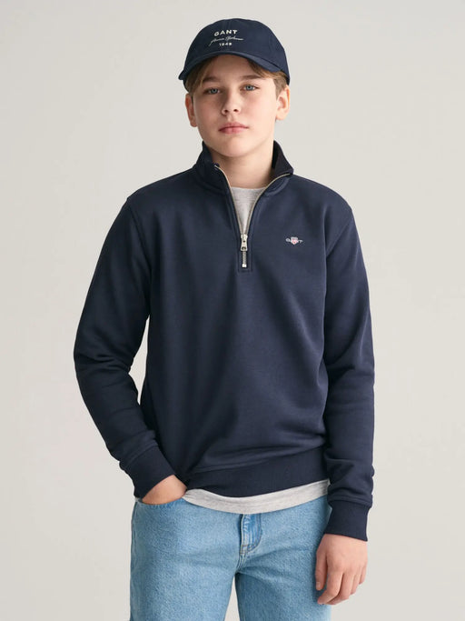 Boy wearing the GANT half zip sweatshirt.