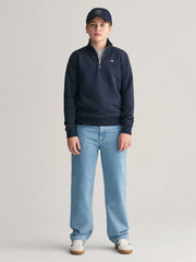 Boy wearing the GANT half zip sweatshirt.