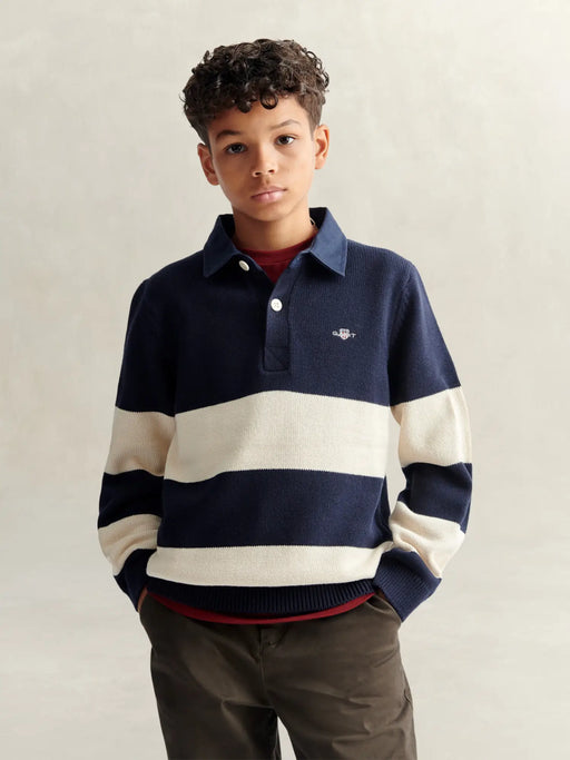 Boy modelling the GANT knitted rugby shirt.