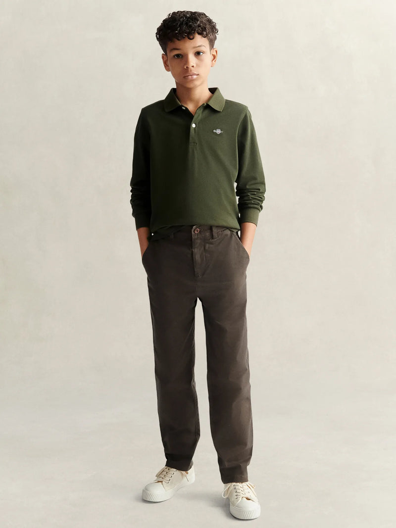 Boy wearing the GANT long sleeve polo shirt.