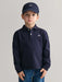 Boy modelling the GANT long sleeve rugby shirt.