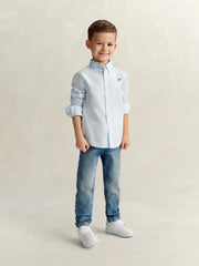 Boy modelling the GANT pinstripe oxford shirt.