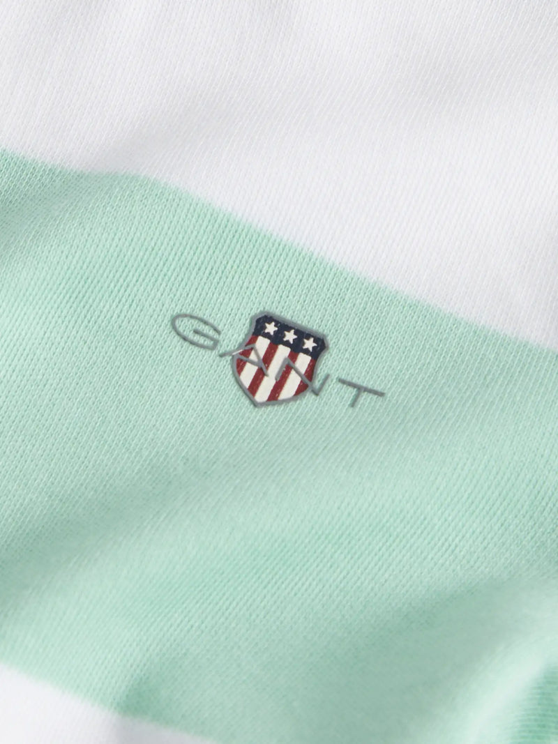Closer look at the GANT striped romper showing detail of the shield logo on the chest.