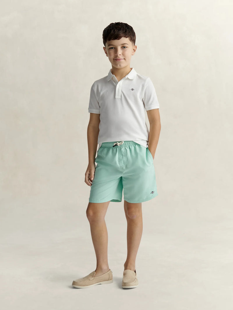 Boy modelling the GANT swim shorts.
