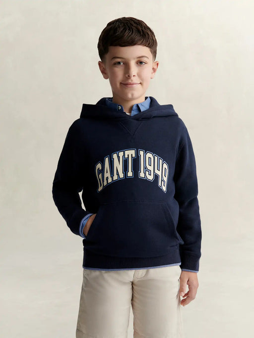 Boy modelling the GANT varsity hoodie.
