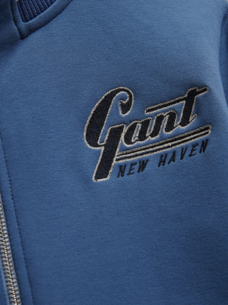 Closer look at the GANT zip up sweatshirt showing detail of the embroidered New Haven logo.