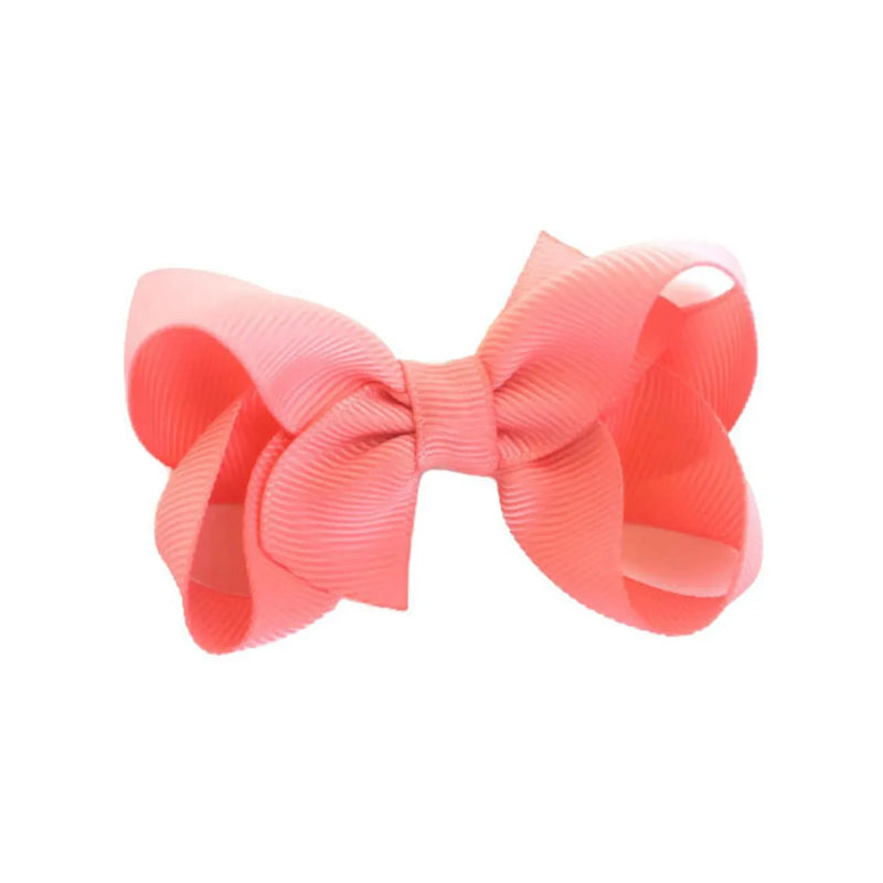 Girls coral bow hair clip. 