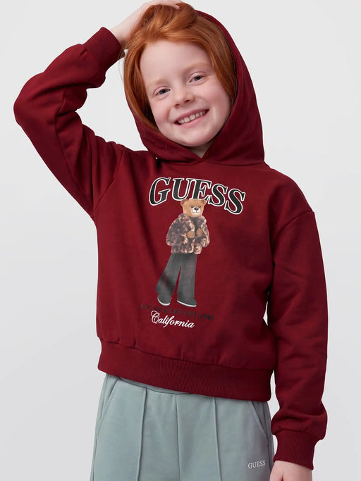 Smiling Girl modelling the Guess bear hoodie.