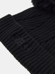 Closer look at the Guess bobble hat showing detail of the embroidered logo.