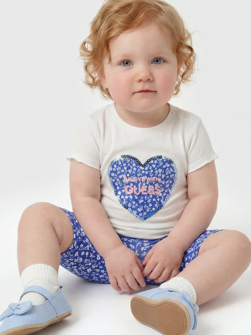 Baby girl wearing the Guess capri leggings set.