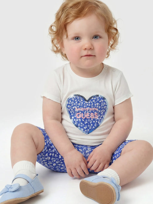 Baby girl wearing the Guess capri leggings set.