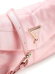 Closer look at the Guess crossbody bag showing detail of the triangle logo badge.
