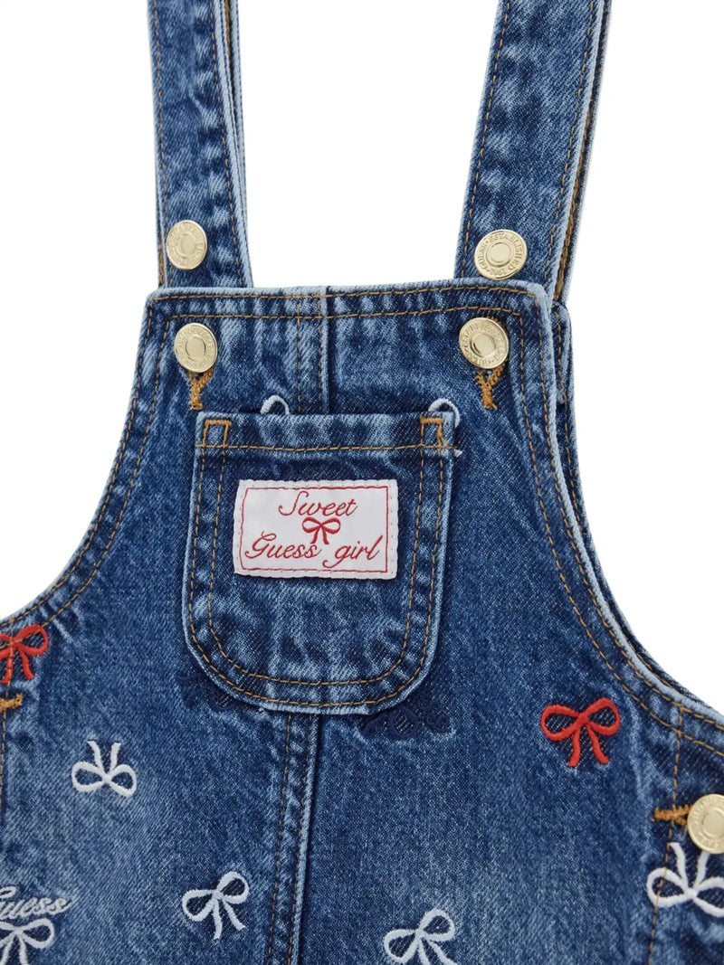Guess denim pinafore with embroidered bow pattern.