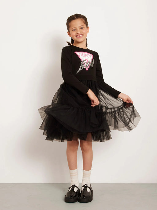 Smiling girl modelling the Guess tulle dress.